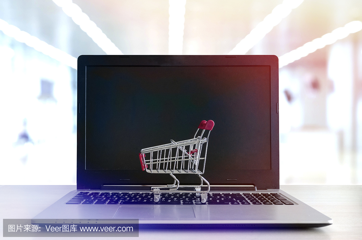 網(wǎng)上購物概念:筆記本電腦上的迷你購物車